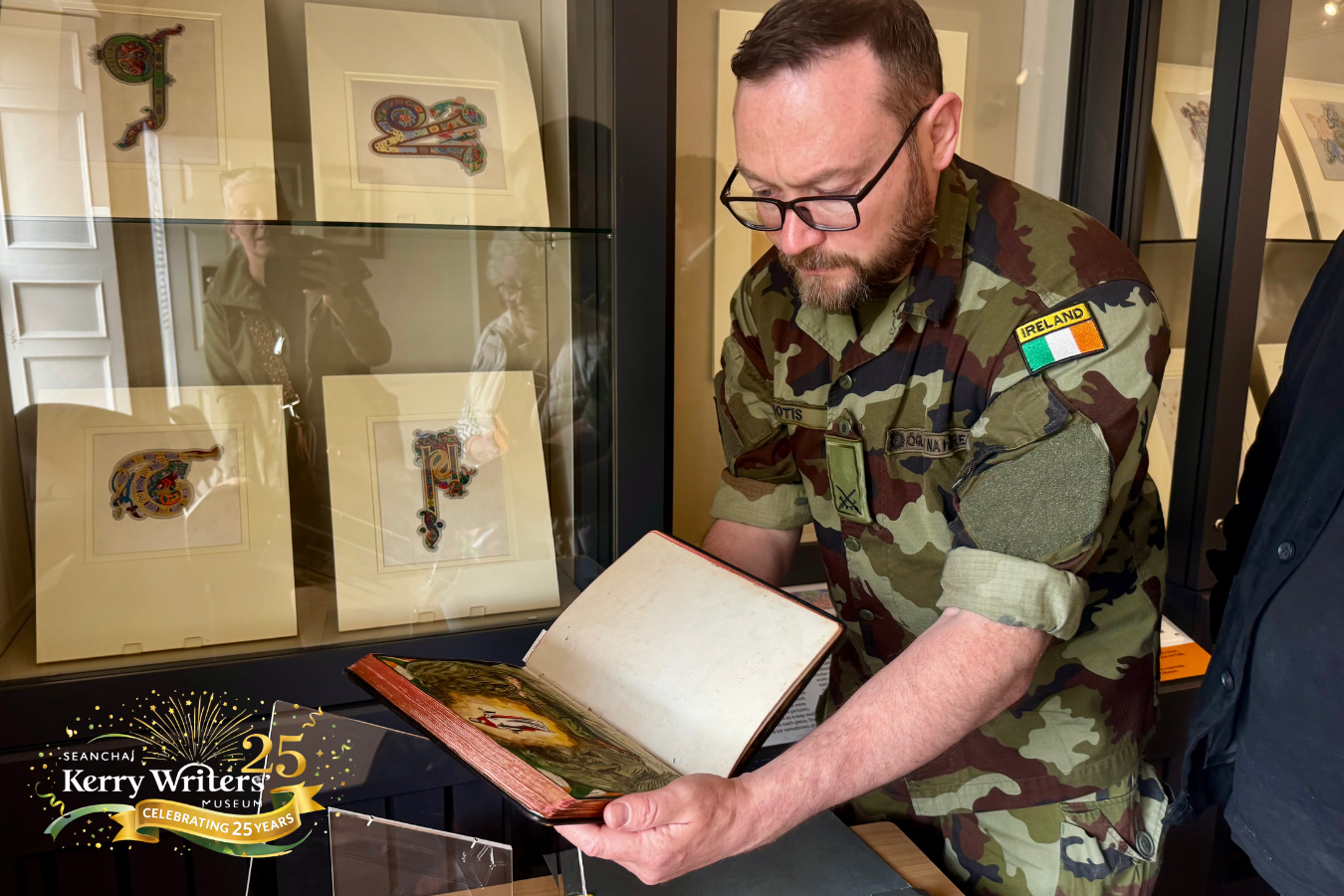 Book of Ballykinlar | Daniel Ayiotis, Director of the Military Archives, examining the volume and its remarkable detail in Kerry Writers” Museum, May 2026 | Courtesy of Military Archives