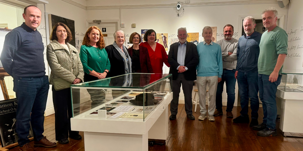 Members of the Kelly family gathered around Éamon's hat in the exhibition.